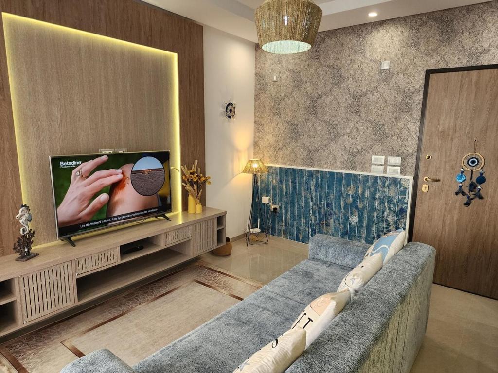 a living room with a couch and a flat screen tv at Fantastic Appartment SeaView Sousse in Akouda