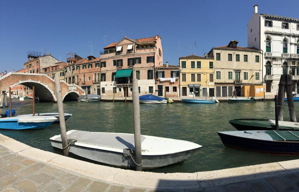 a group of boats in a canal with buildings at Princess Canal View NEW Guest House 2023 in Venice