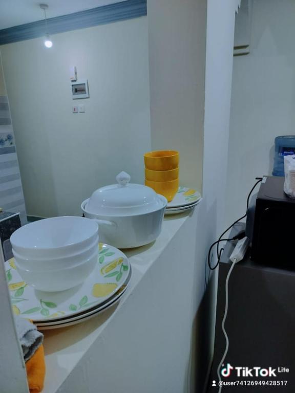 a kitchen counter with bowls and plates on it at Mwangaza in Mombasa