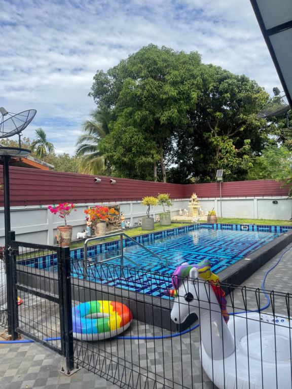 a swimming pool with a pool noodle in front of it at Saensuk stay in Ban Wang Thong