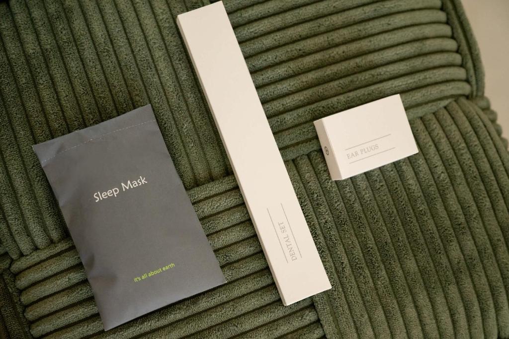 two books sitting on top of a bed at Estia Premium Apartments - Luxury Kingbed Studio Vackhou 1 in Thessaloniki