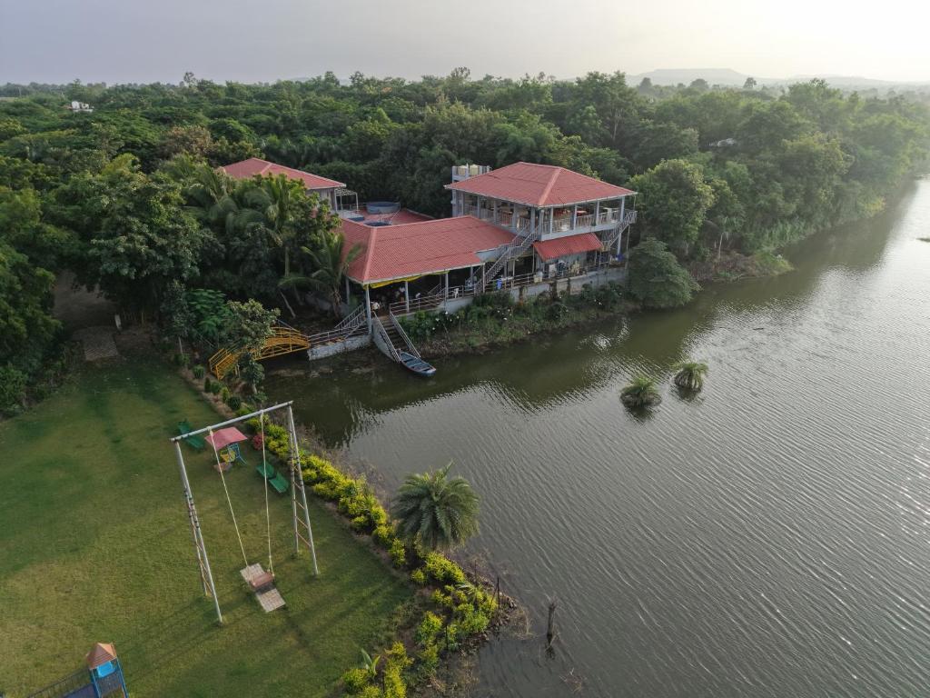 an aerial view of a house in the middle of a river at Neel Farms and Resort in Saoner
