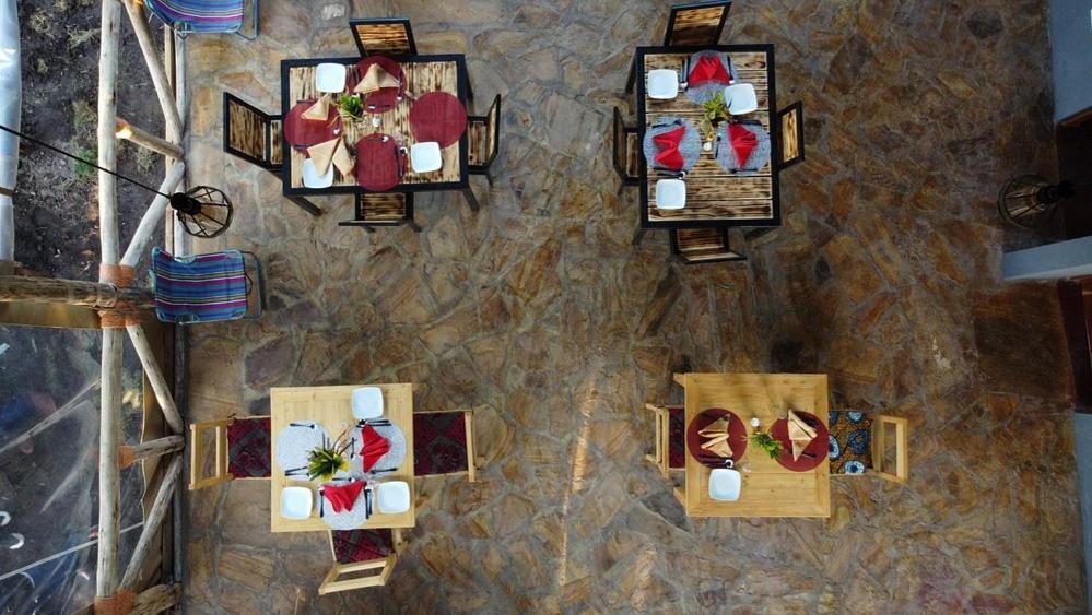 an overhead view of a room with tables and chairs at Jangwani Riverview Suits in Mto wa Mbu