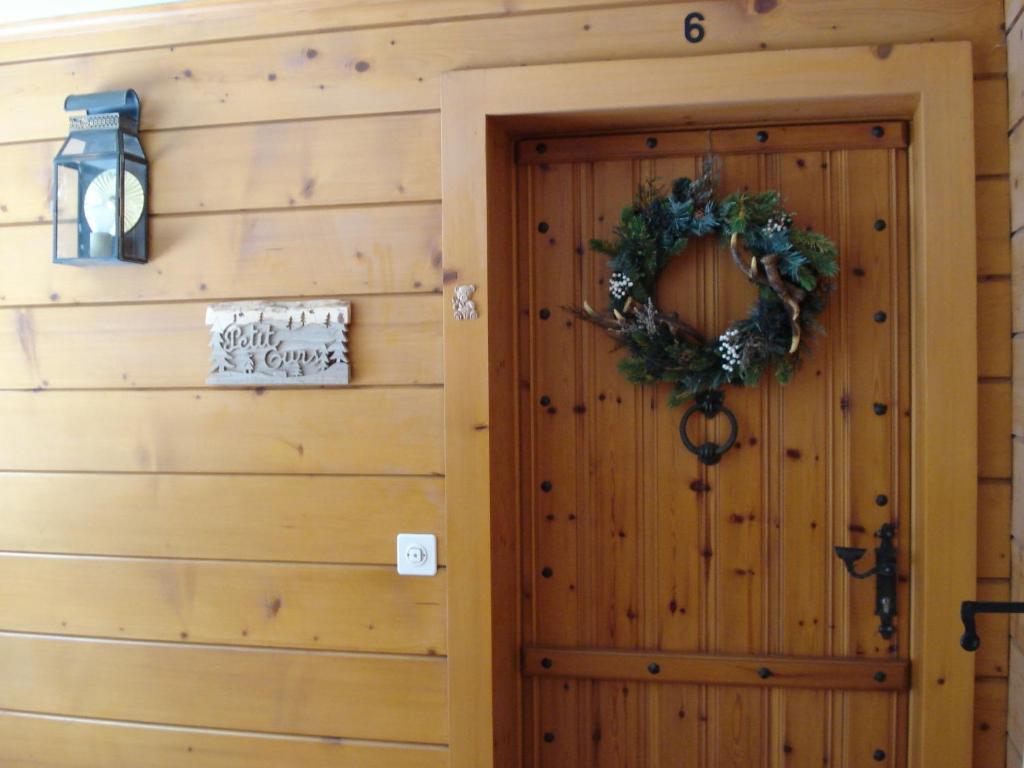 a door to a cabin with a christmas wreath at Petit Ours in Villars-sur-Ollon