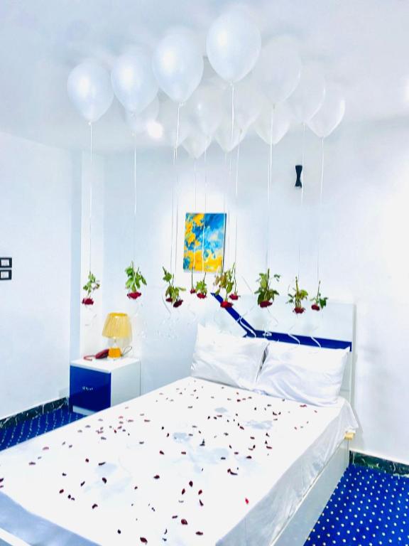 a bedroom with a bed with confetti on it at Istanbul HOTEL Minya in Minya