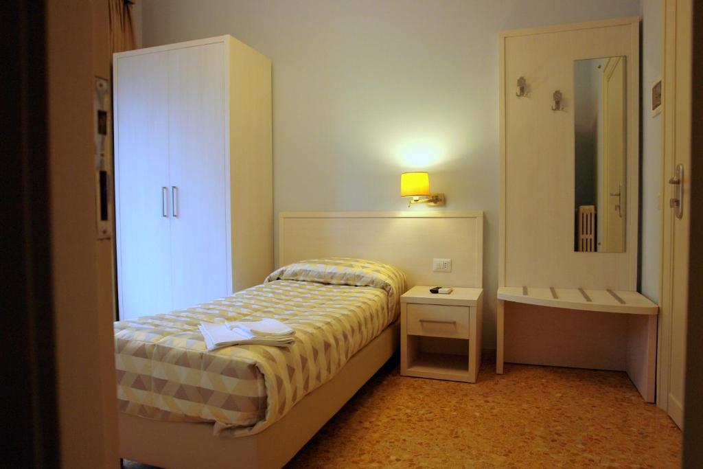 Łóżko lub łóżka w pokoju w obiekcie Casa per Ferie Ravasco San Pietro