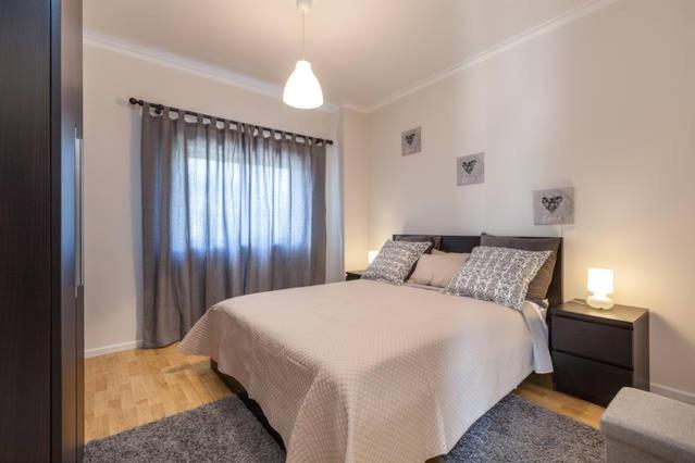 a bedroom with a large bed and a window at Carvalhosa Apartment in Monte