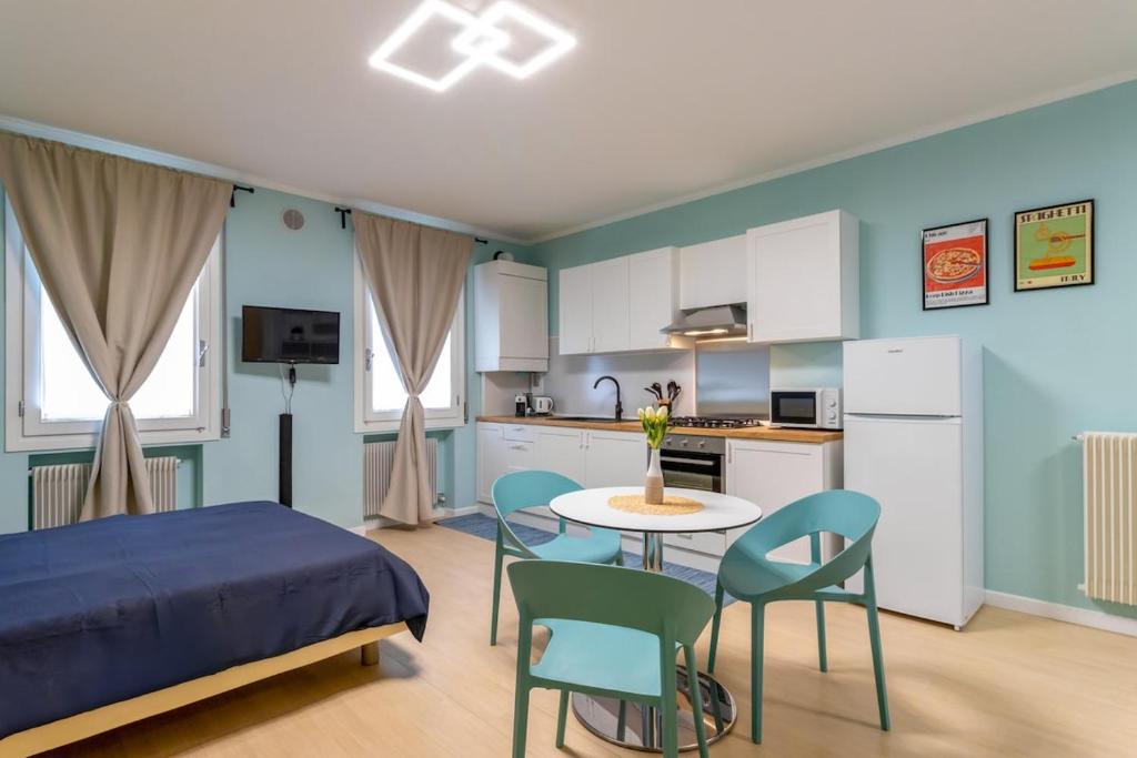 een slaapkamer met een bed, een tafel en stoelen bij Cozy apartment in Castelfranco Veneto