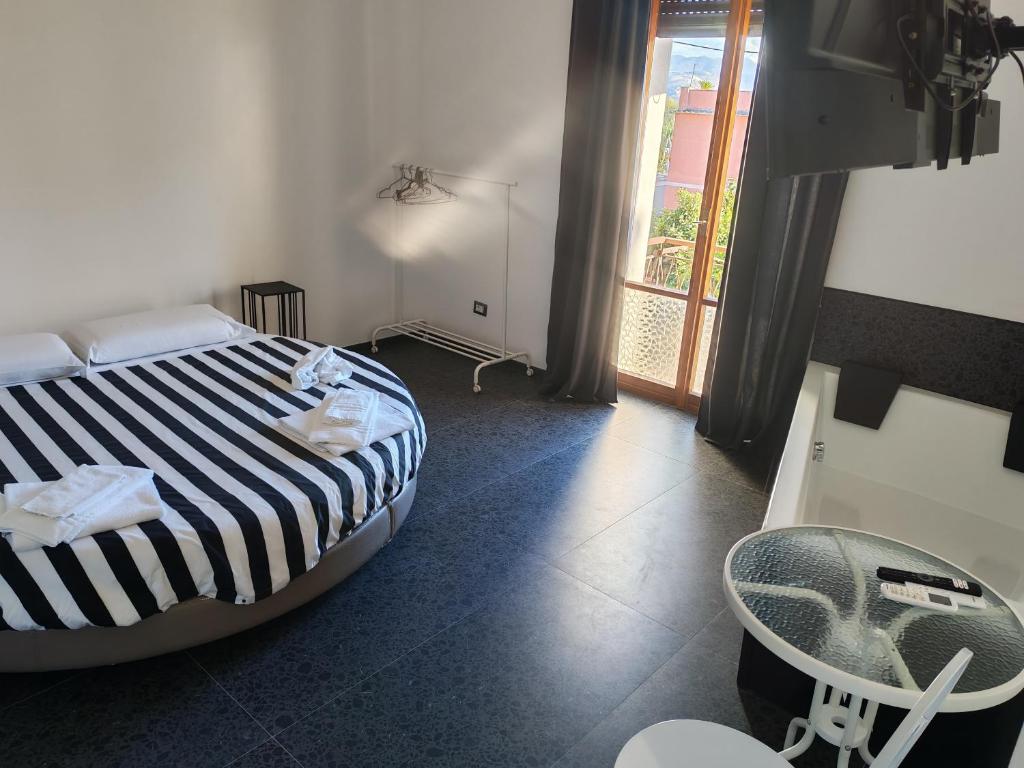 a bedroom with a bed and a chair and a window at Babbo maison in Guidonia
