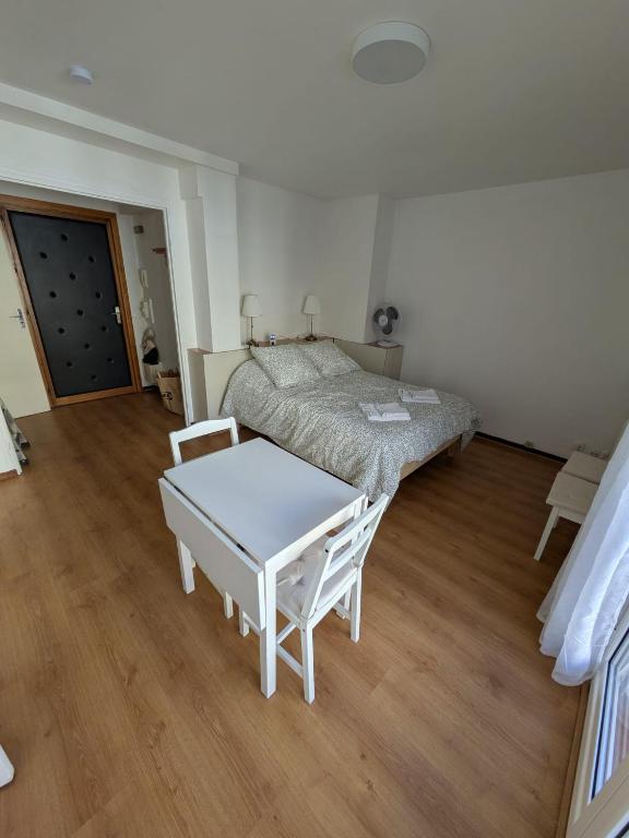 a bedroom with a bed and a table in it at Le petit casino in Menton