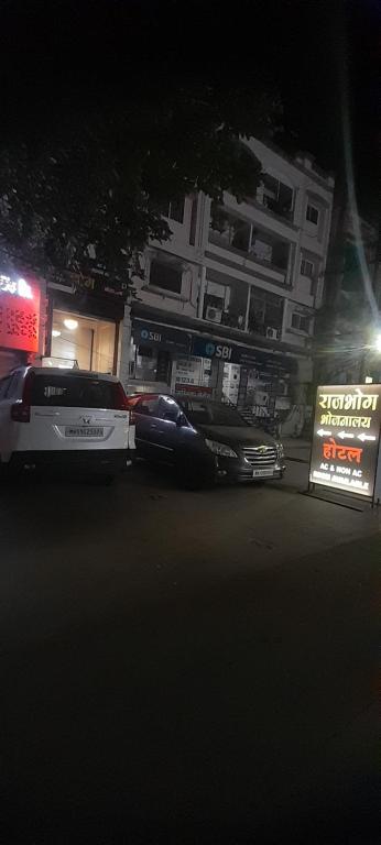 a car parked in a parking lot at night at HOTEL RAJBHOG indore in Indore
