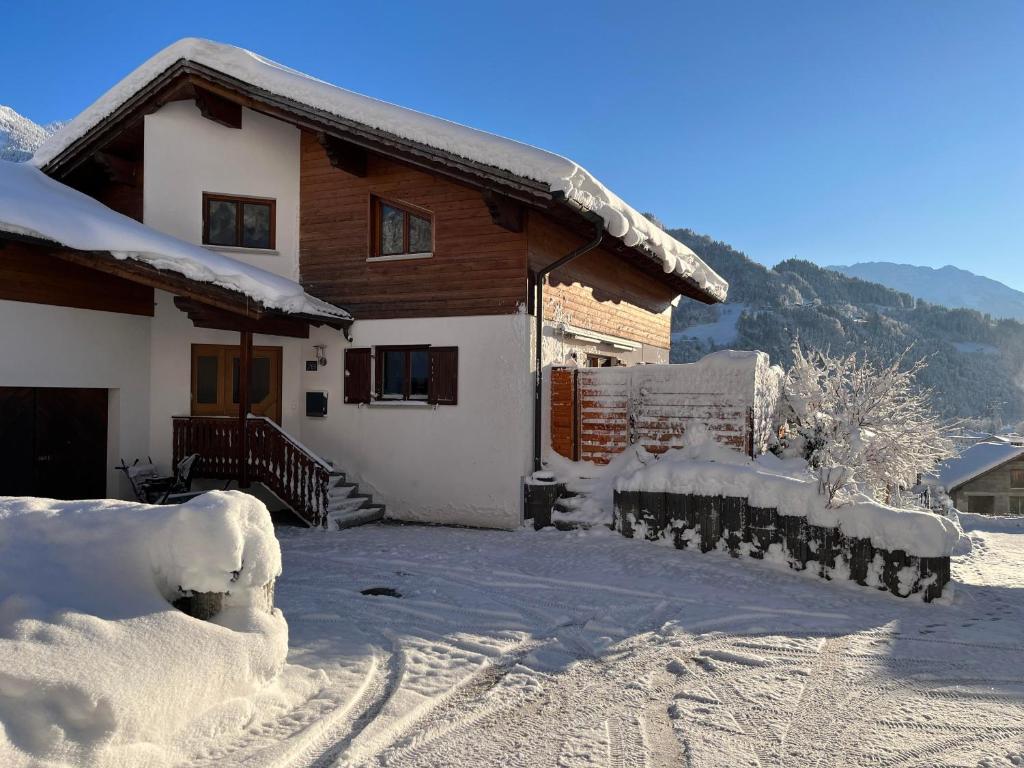 a house covered in snow in front at Ferienwohnung Thöny in Vandans