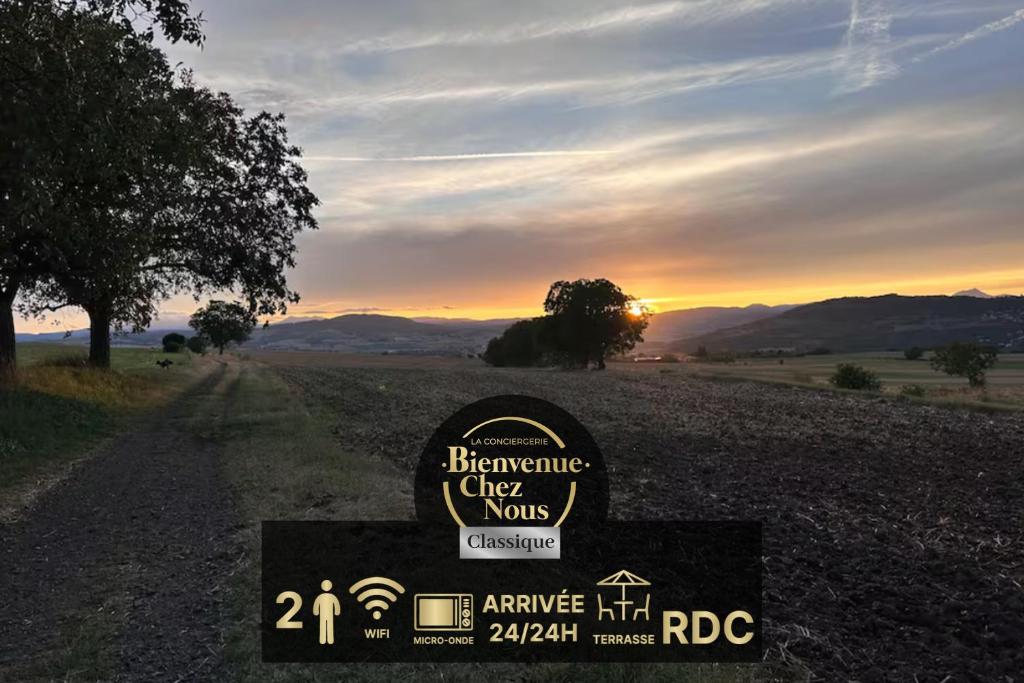 a sign in a field with the sunset in the background at Unique Chambre 1 Centre Équestre Snack in Vic-le-Comte