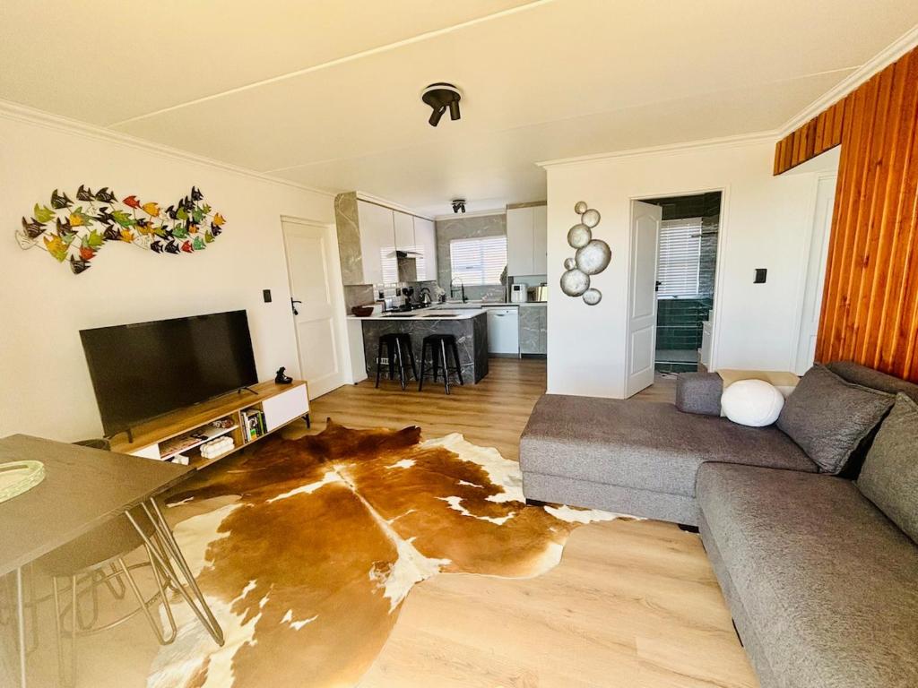 a living room with a couch and a table at Stanley's Place at 212 Salerno in Cape Town