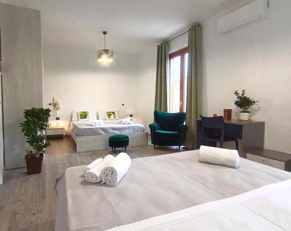 a hotel room with two beds and a desk at B&B A' Kiazza in Buompietro