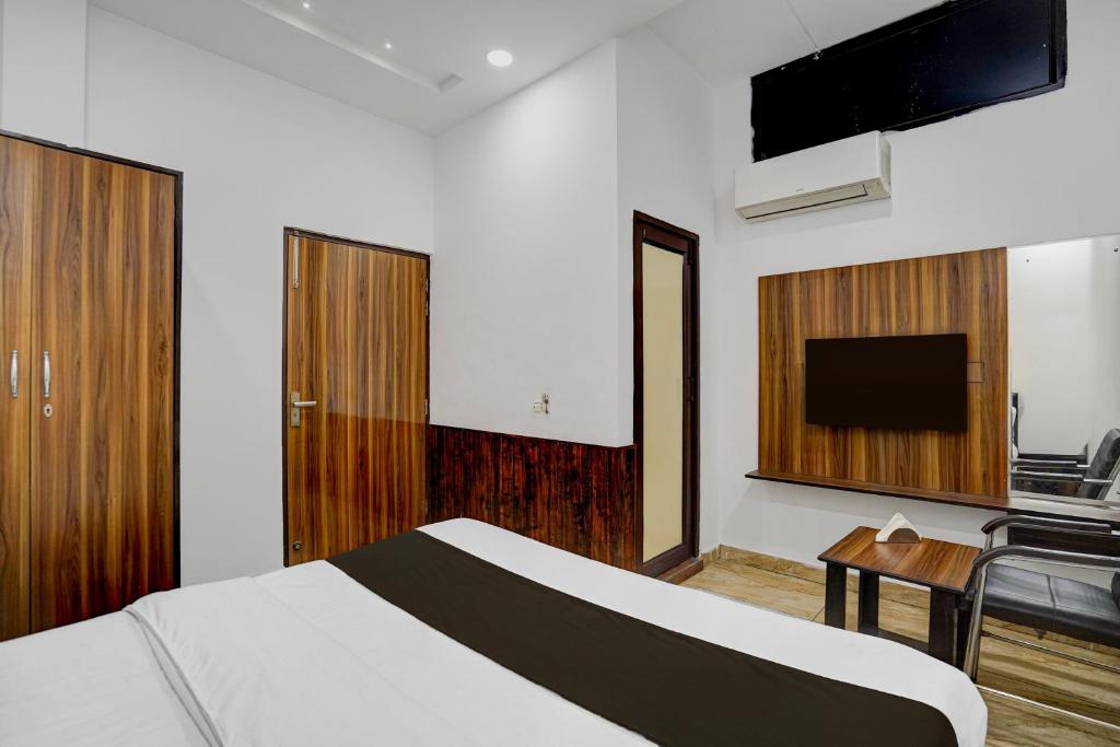 Una habitación de hotel con una cama y un televisor de pantalla plana. en Hotel O Silver Arc Mall Ludhiana Formerly White Solitaire, en Ludhiana