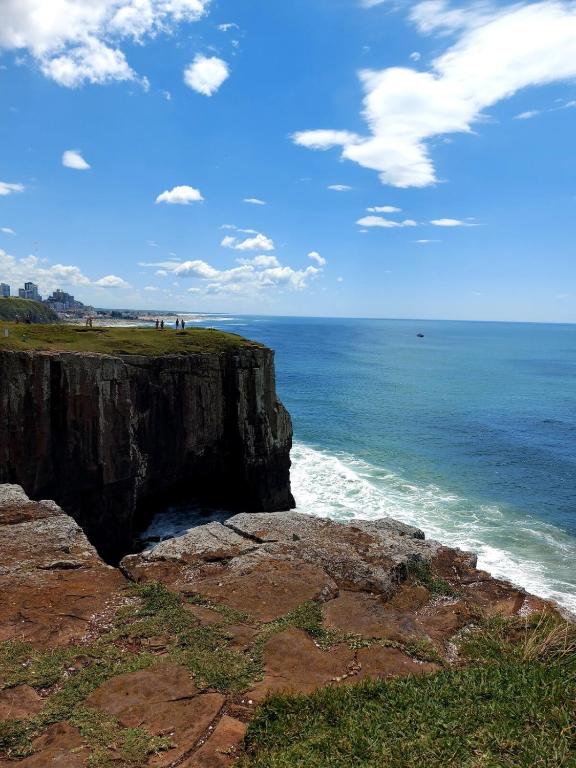 a view of the ocean from a cliff at Aproveitando o Sol e o Mar de Torres in Torres