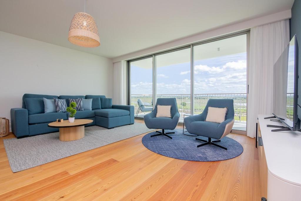 a living room with two chairs and a couch at Bayline X in Armação de Pêra