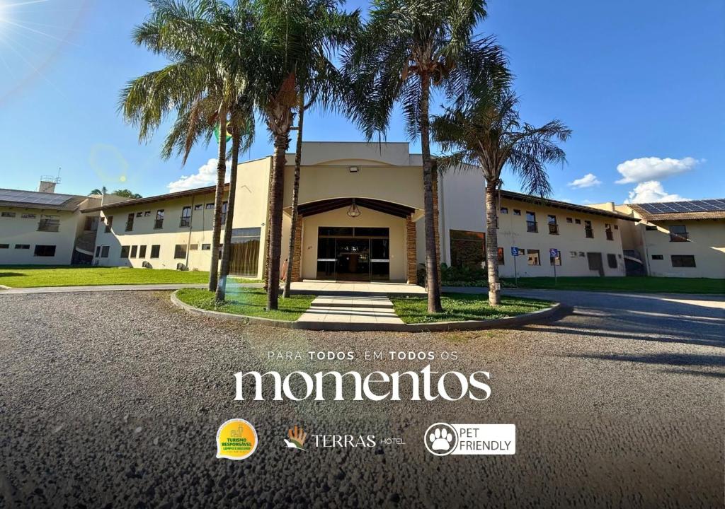 a building with palm trees in front of it at Terras Hotel in Lucas do Rio Verde
