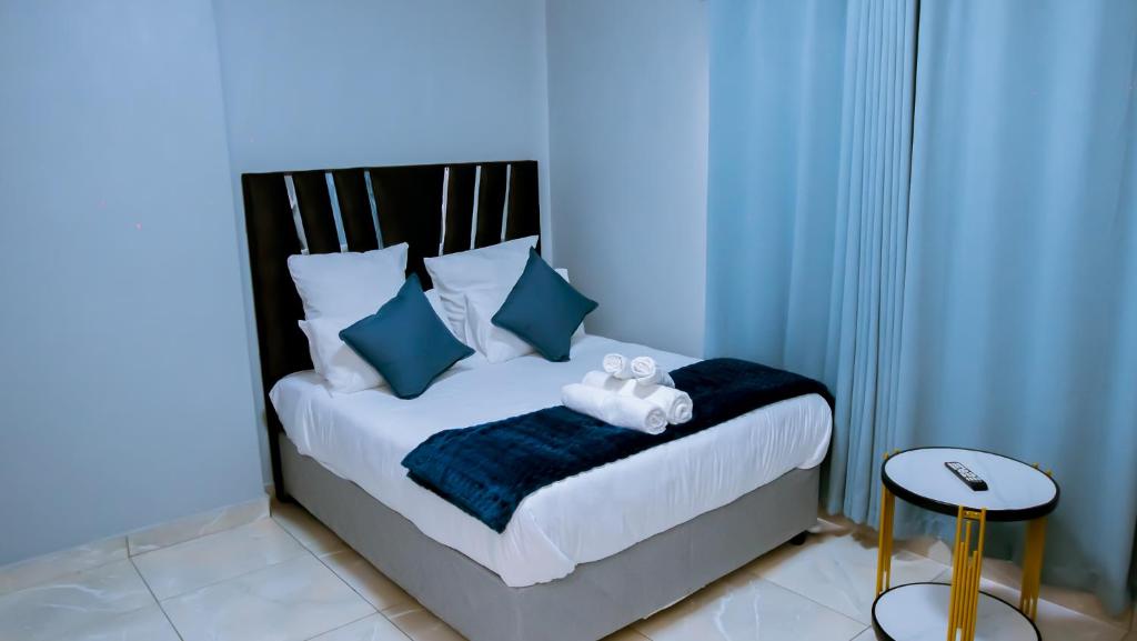 a blue bedroom with a bed with a teddy bear on it at DC Guest House in Avondale