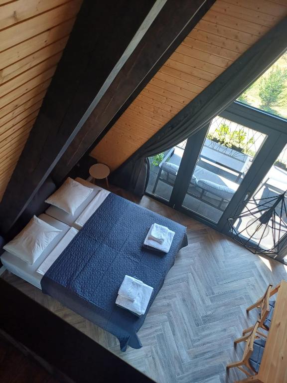 an overhead view of a bed in a attic at A frame Alba Iulia in Alba Iulia