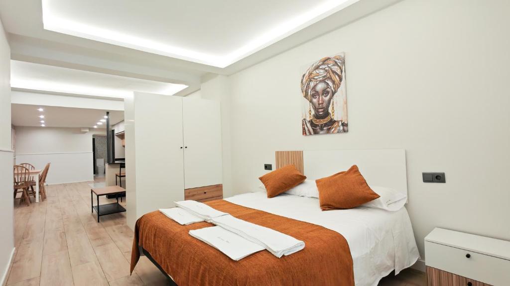 a bedroom with a large bed with towels on it at Apartamentos FLORIDA in Valladolid