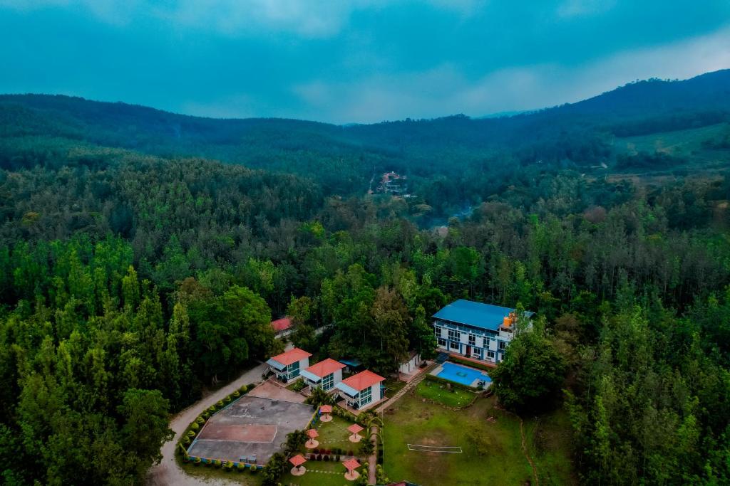 an aerial view of a house in the middle of a forest at The Nature's Nest in Attigundi