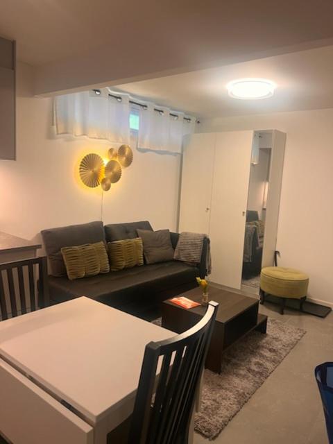 a living room with a couch and a table at Furnished apartment with parking in Malmö
