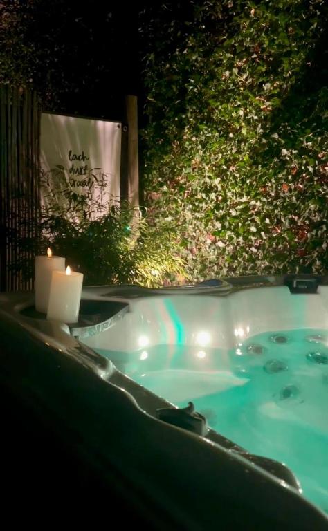 a jacuzzi tub with a candle and a candle holder at Slapen bij van O 1 in Yerseke