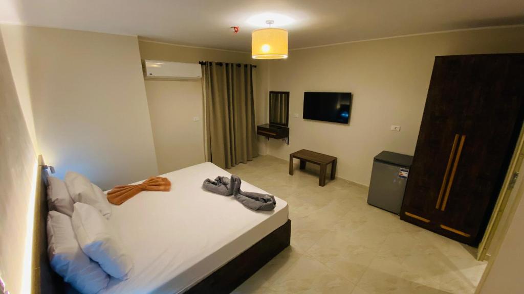 a hotel room with a bed and a tv at Lovely Rivera Room with Breakfast in Cairo