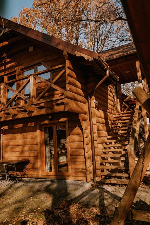 a log cabin with a staircase leading to the door at Sosnowy Domek Piętro Zator Graboszyce Energylandia in Graboszyce