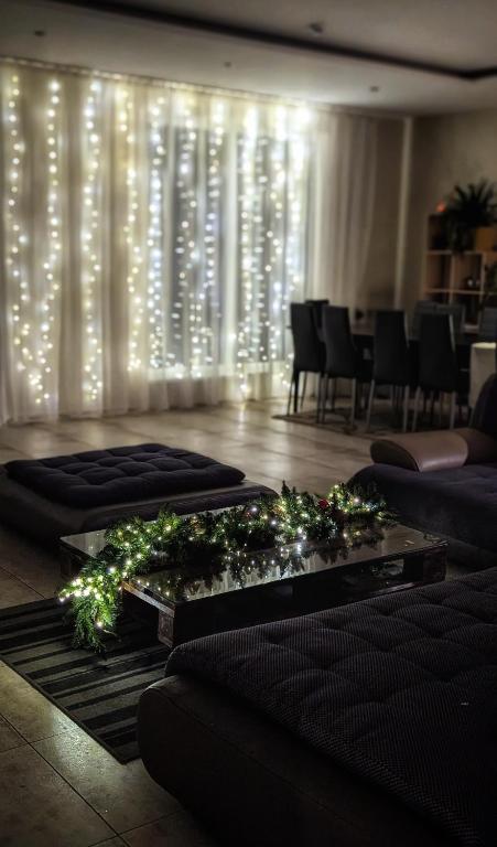 a living room with a bunch of lights on a wall at Baltamiškio slėnis in Baltamiškis