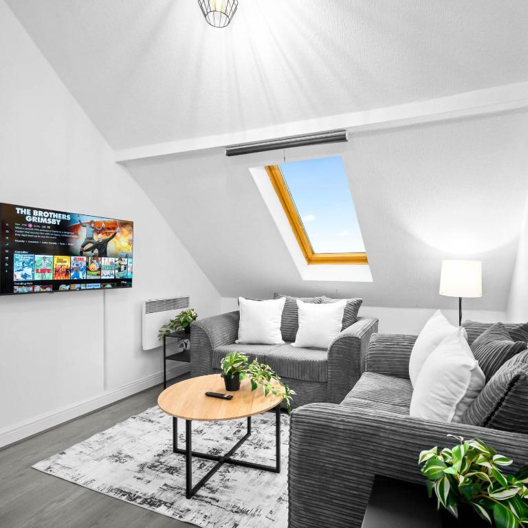a living room with a couch and a table at Modern Apartment - Accommodates 4 - On Street Parking - Neftlix 2CR in Birmingham