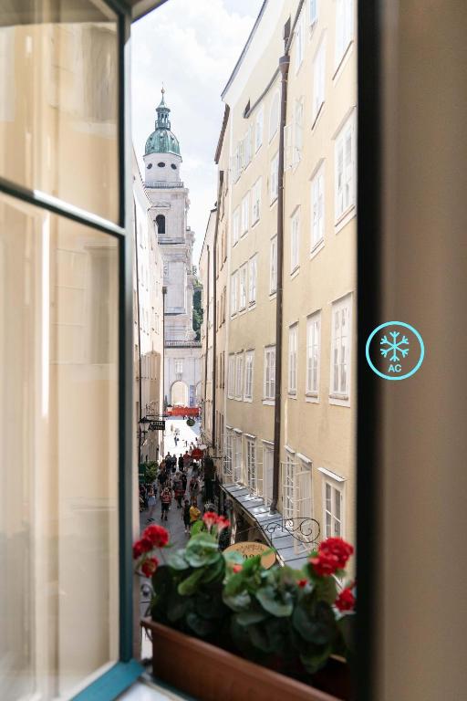 a view of a city street from a window at Altstadt-App. Domblick! in Salzburg