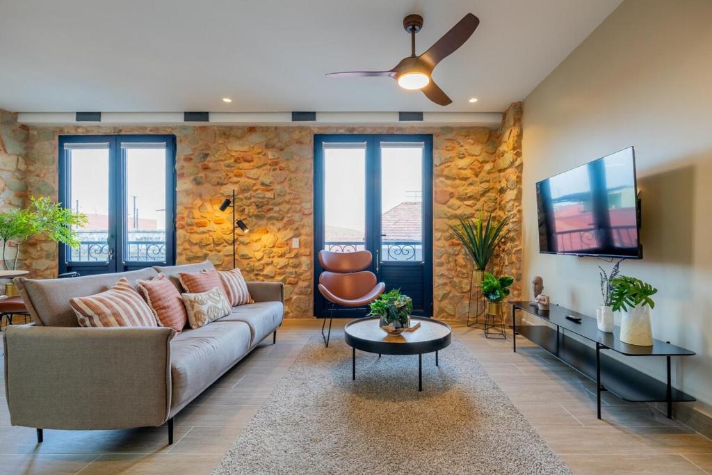 a living room with a couch and a tv at La Cuadra - Casco Viejo in Panama City