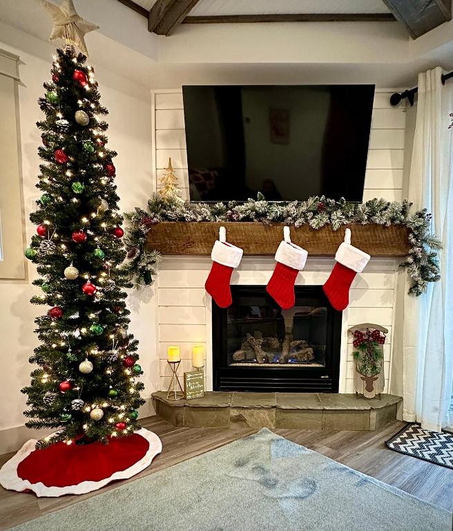 a christmas tree in a living room with a fireplace at Pony Trail in Collingwood