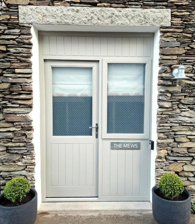 a garage door with a sign that reads the ways at The Mews Room at The Coach House in Windermere
