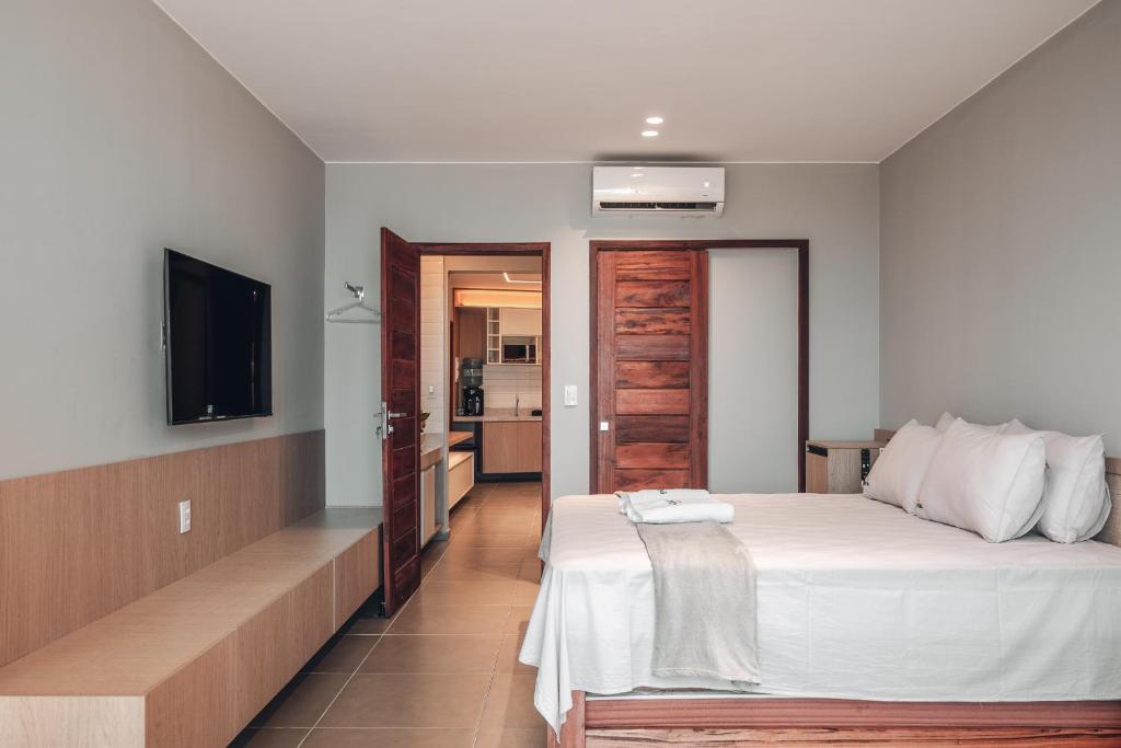 En eller flere senge i et værelse på Apartamentos Barra Grande - APEBG