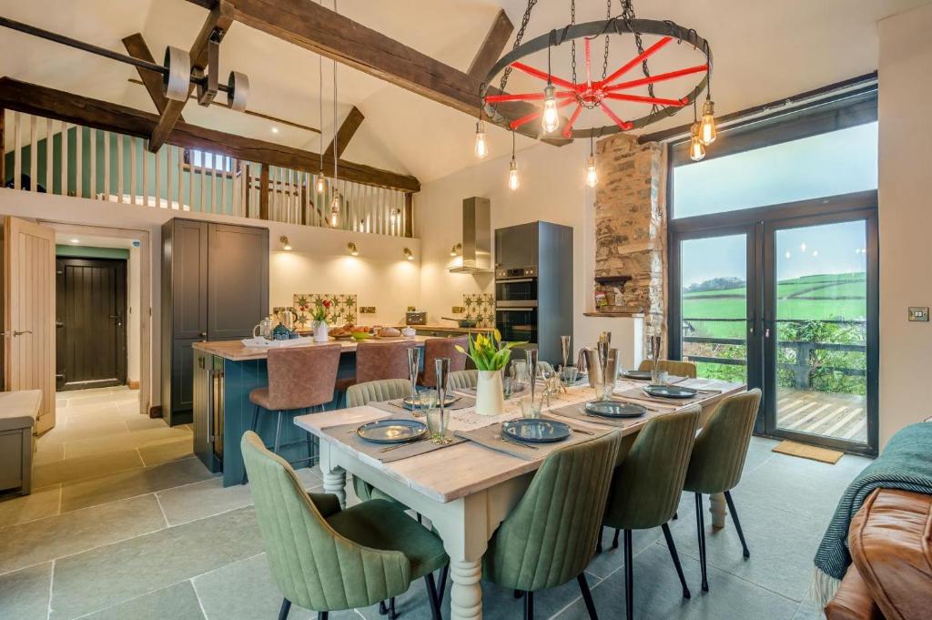 an open kitchen and dining room with a table and chairs at 3 Bed in Dulverton oc-t32975 in Dulverton