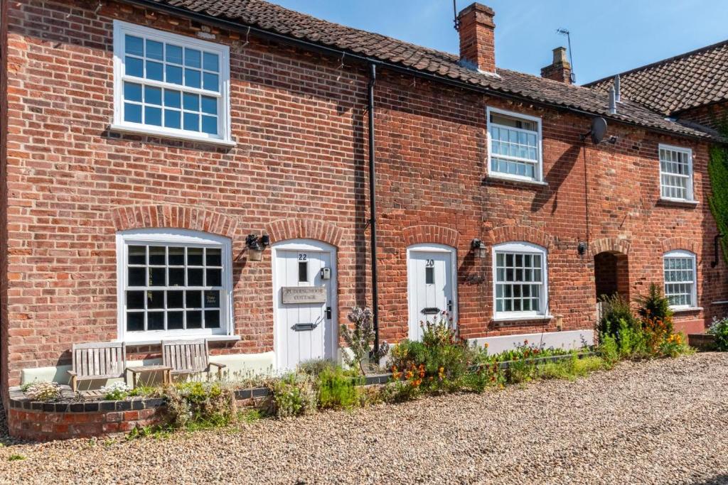 a red brick house with white doors and windows at 2 Bed in Beccles oc-puddin in Beccles