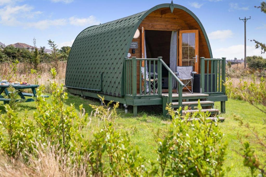 a green dome tent in a field with a table at 1 Bed in Four Lanes oc-b32769 in Carnbrea