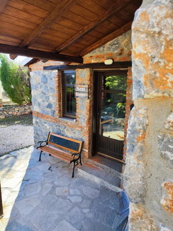 a bench sitting in front of a building at Nest Suite in Palaios Agios Athanasios