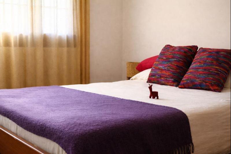 En eller flere senge i et værelse på Casa Suyay