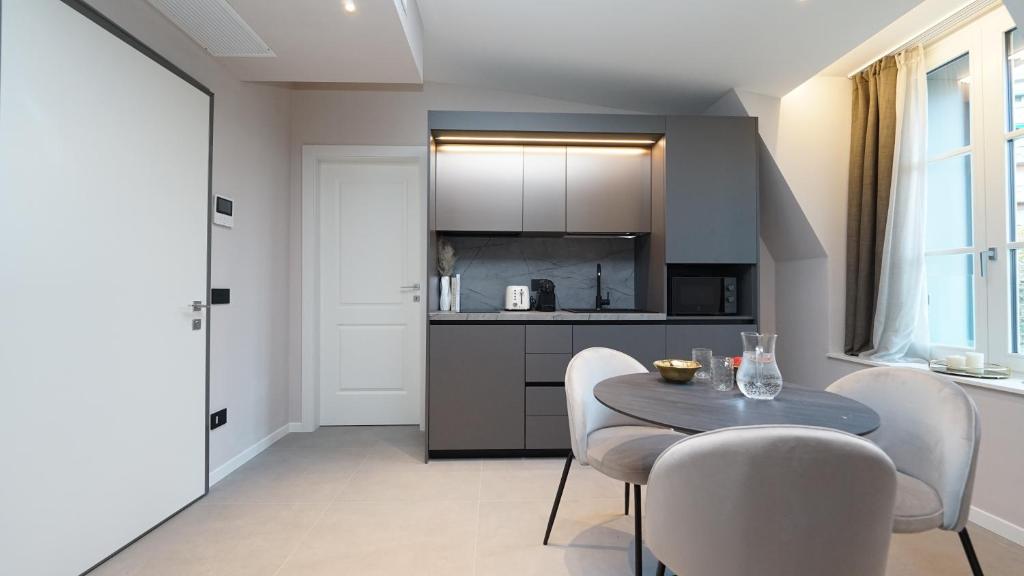 a kitchen with a table and chairs in a room at Be Mate Citylife in Milan