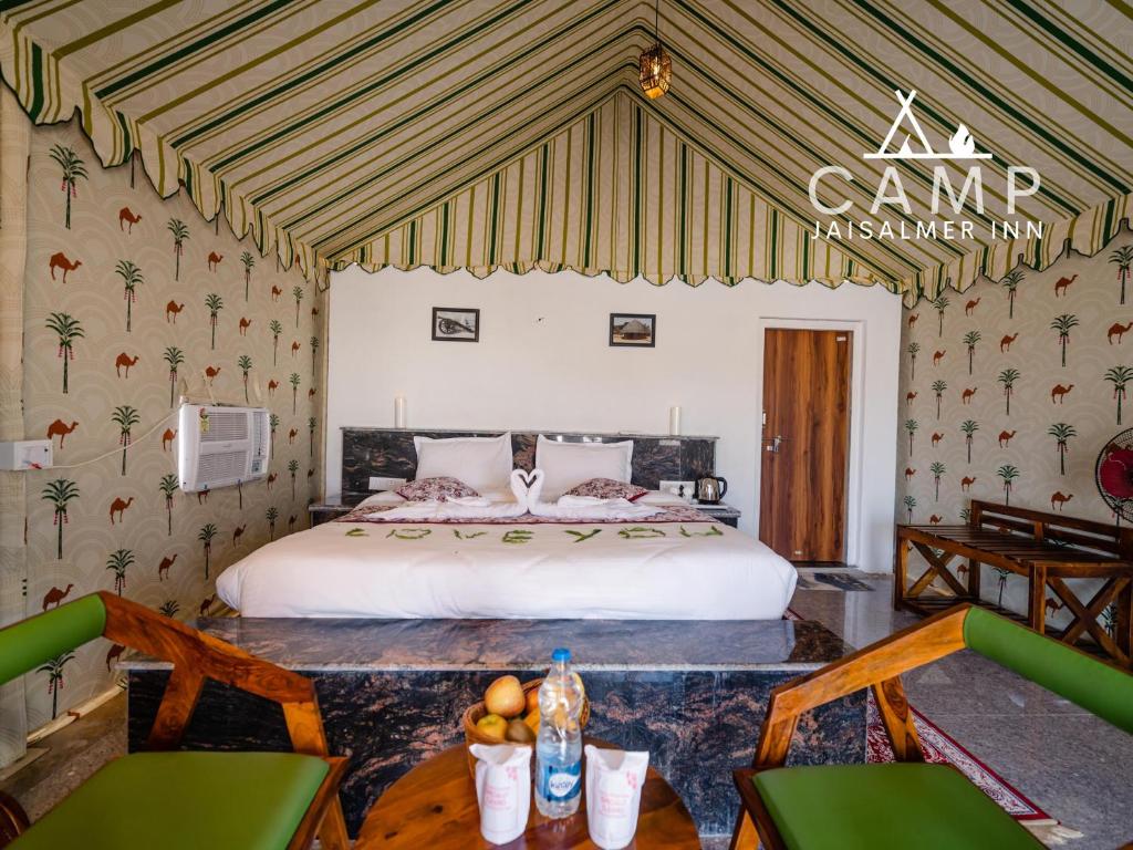 a bedroom with a large bed in a room at Camp Inn Jaisalmer Resort in Jaisalmer