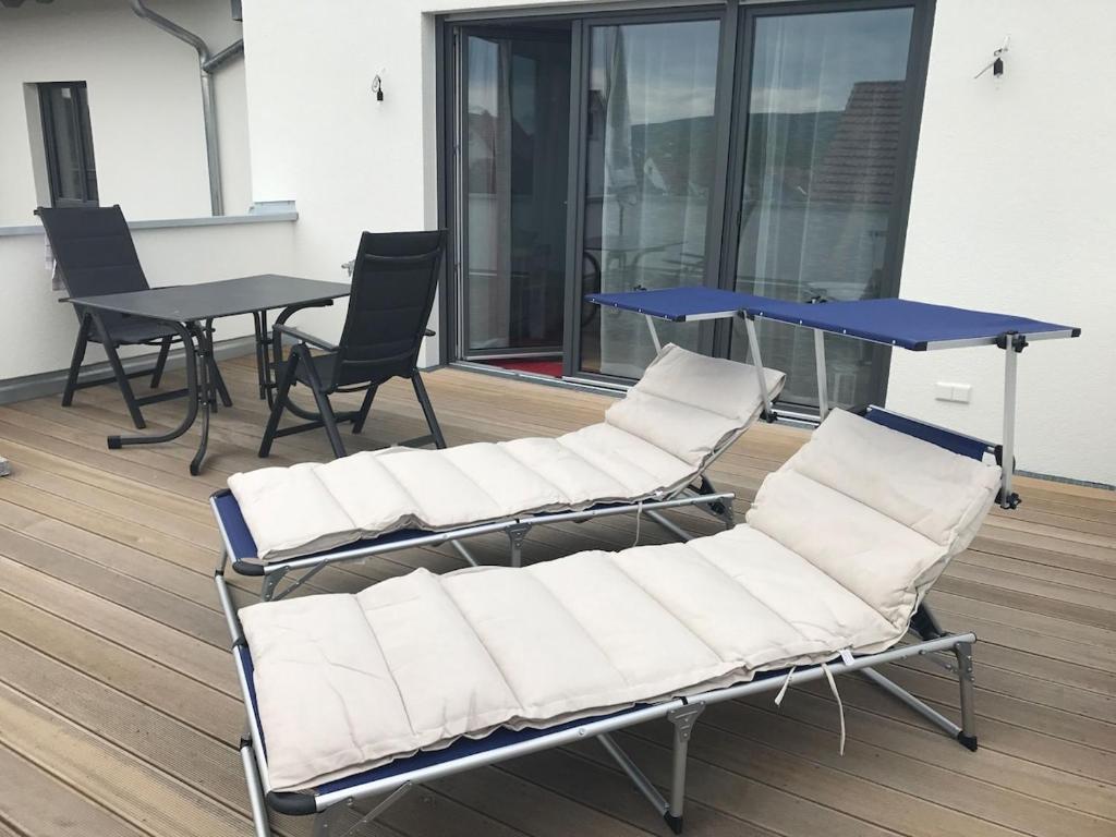 a group of chairs and a table in a room at Seeterrasse in Allensbach