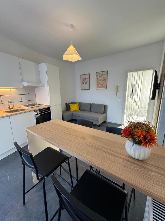 a kitchen and living room with a table and chairs at Schönes Apartment für 5 Personen nahe Zentrum & Borussia Park MG77 in Mönchengladbach
