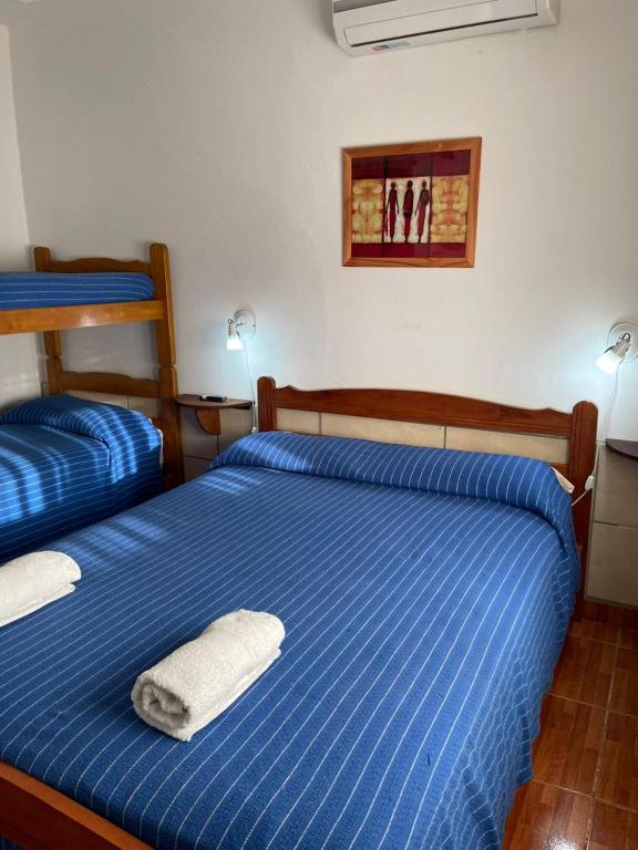 een slaapkamer met twee bedden met handdoeken erop bij Are-Kepay in Villa Carlos Paz