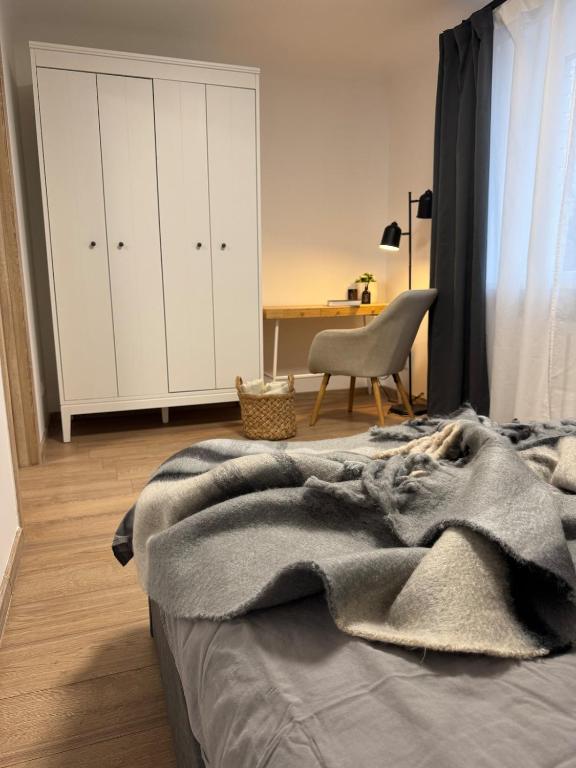 a bedroom with a bed with a blanket on it at Cozy Center Apartment in Jelgava