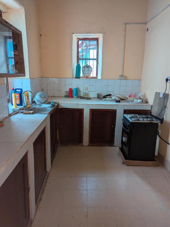 a kitchen that is being remodeled with a stove at Hamza Hostel in Zanzibar City